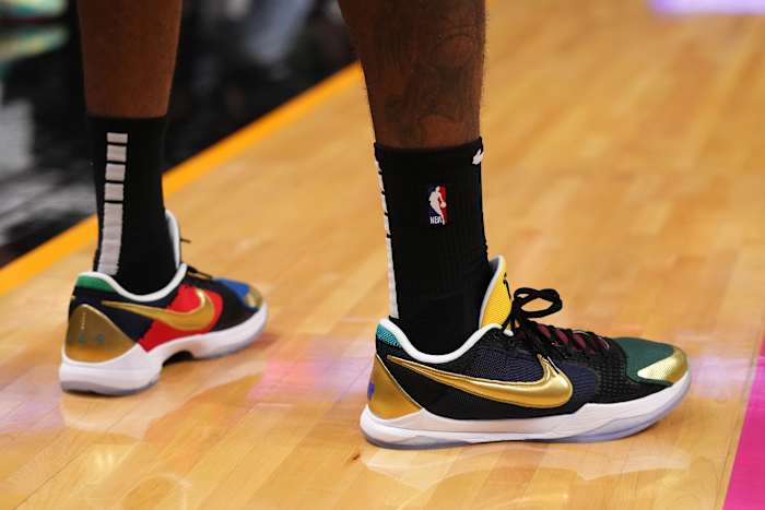 View of black and gold Nike Kobe shoes.